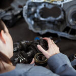 a girl performing transmission repair work in a shop Las Vegas