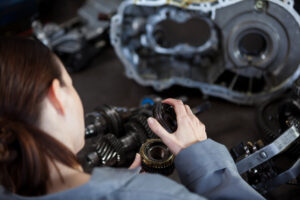 a girl performing transmission repair work in a shop Las Vegas
