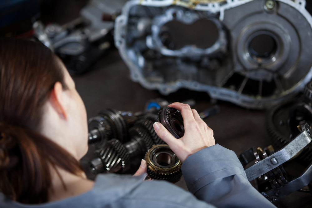 a girl performing transmission repair work in a shop Las Vegas